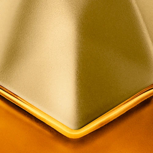 Close-up of engraving location of gold metallic cap of bottle 
