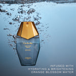 Orabelle Nectar Dew bottle with gold cap underwater on a blue gradient background