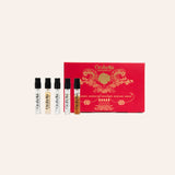 A set of four small perfume sample vials displayed in front of a red presentation box with ornate gold detailing. The box is branded 'Orbella Perfumes' and reads 'Scent of the Gods'.