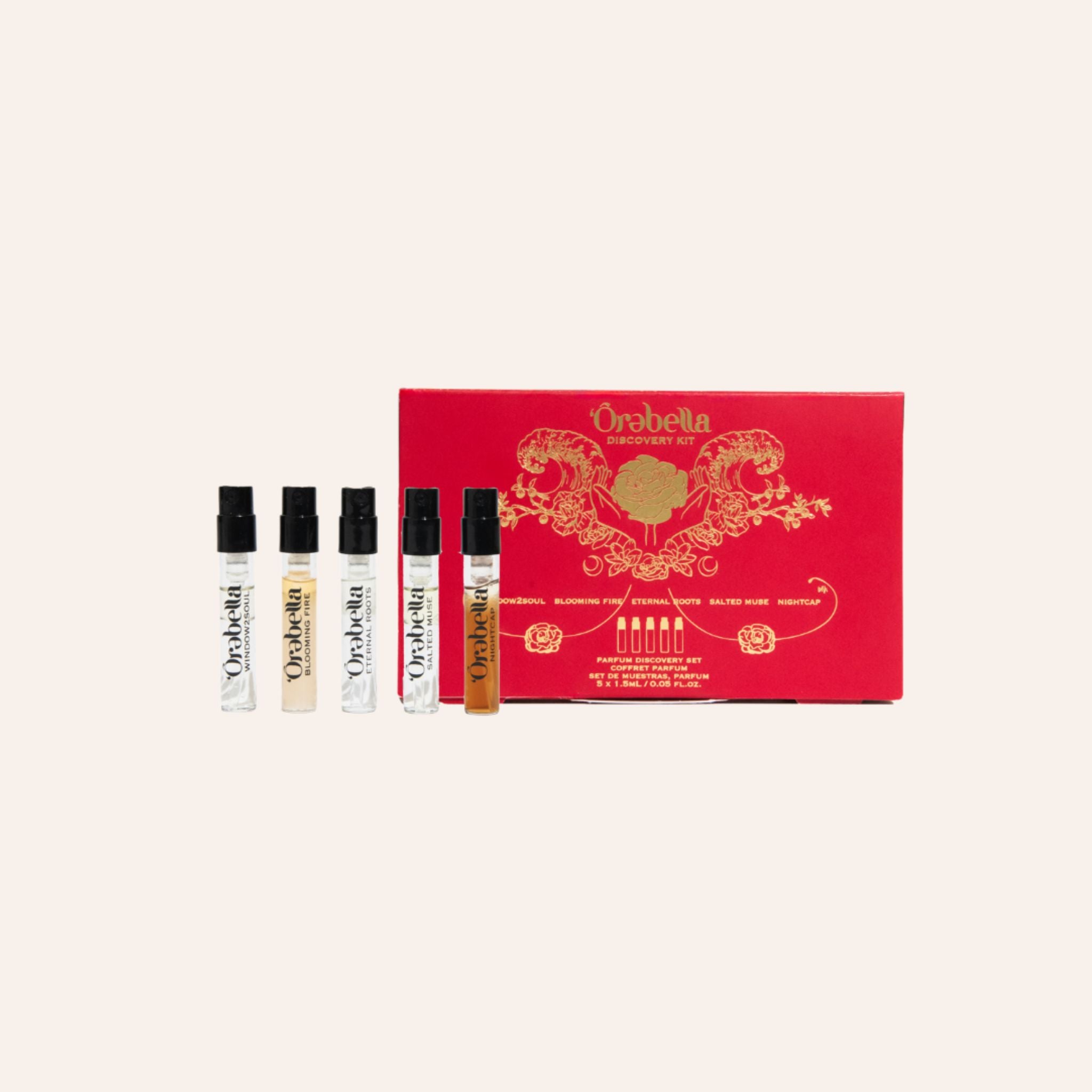 A set of four small perfume sample vials displayed in front of a red presentation box with ornate gold detailing. The box is branded 'Orbella Perfumes' and reads 'Scent of the Gods'.