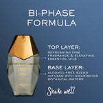 Perfume bottle with bi-phase formula description on a blue background