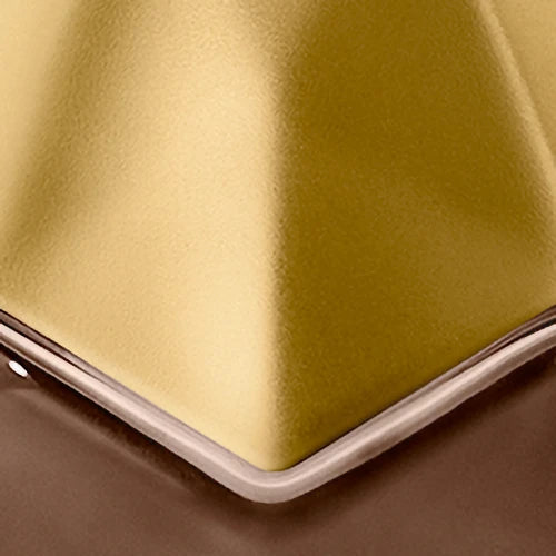 Close-up of engraving location of gold metallic cap of bottle 